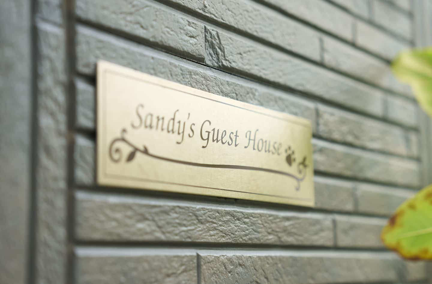 Brass nameplate of Sandy's Guest House